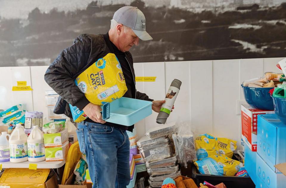 Volunteer sorting through donations.