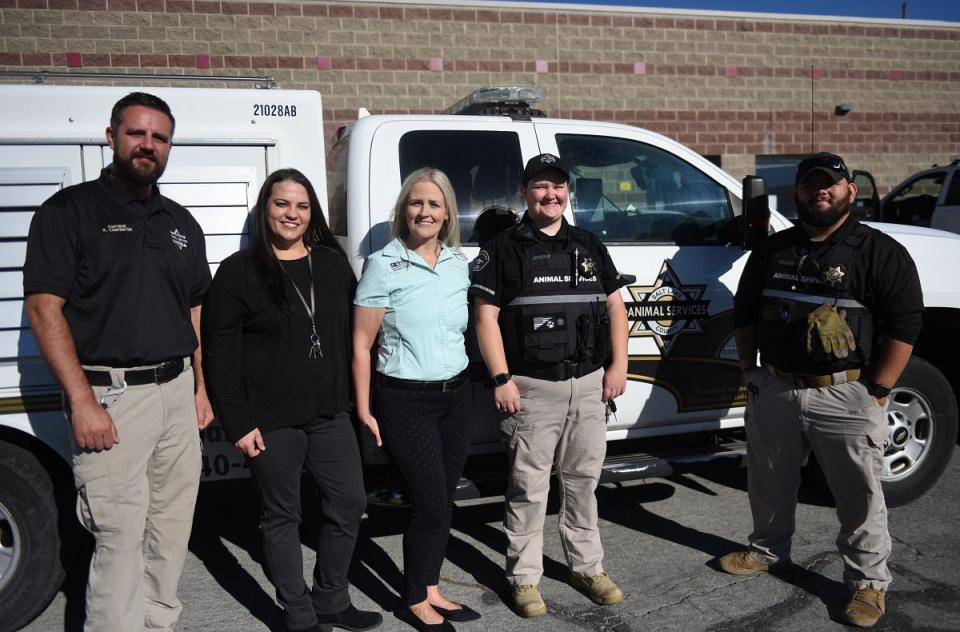Field Services Officers standing next to animal control truck.