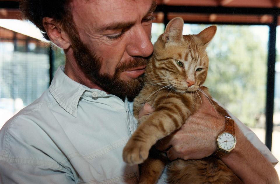Michael Mountain holding an orange tabby cat