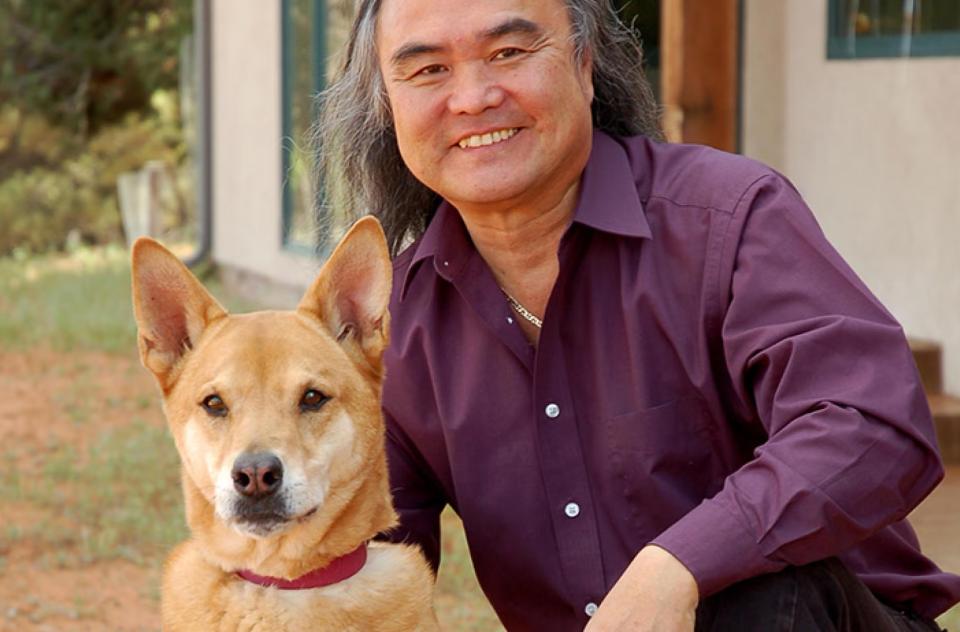 Steven Hirano beside a brown dog