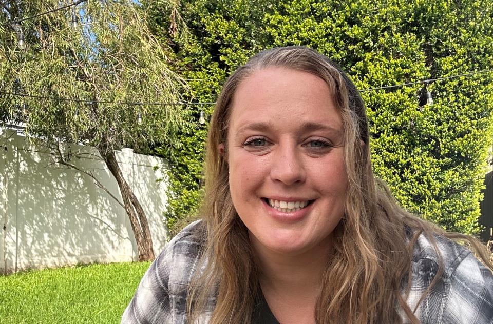 Tracy Hahn outside with a black dog