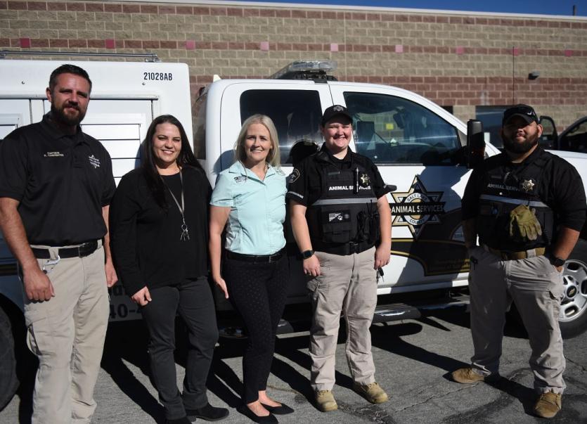 Field Services Officers standing next to animal control truck.