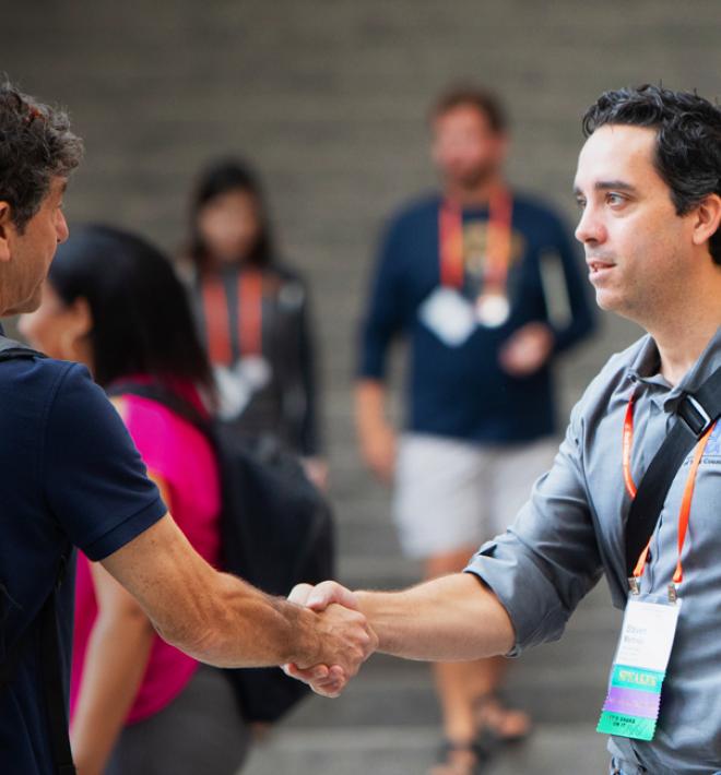 Two Best Friends National Conference attendees shaking hands