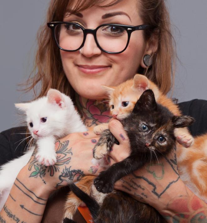 woman holding kittens