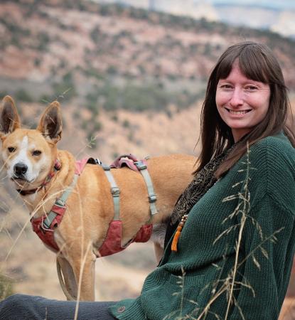 woman with medium size brown dog outside with canyon view