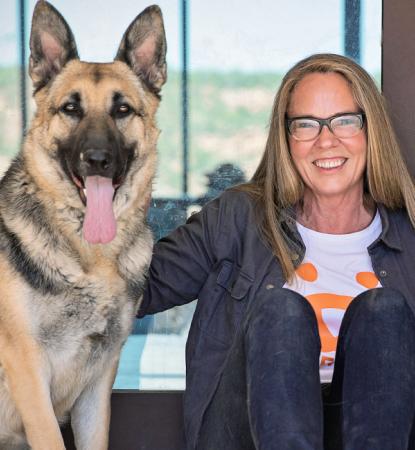Julie Castle Seated with two large dogs