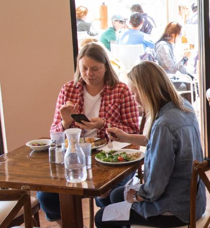 people dining inside and outside at Angel Village Cafe