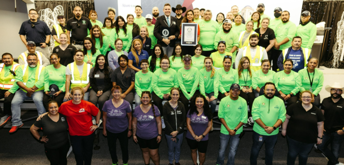 Group photo of Guiness record holders, one holding an official plaque