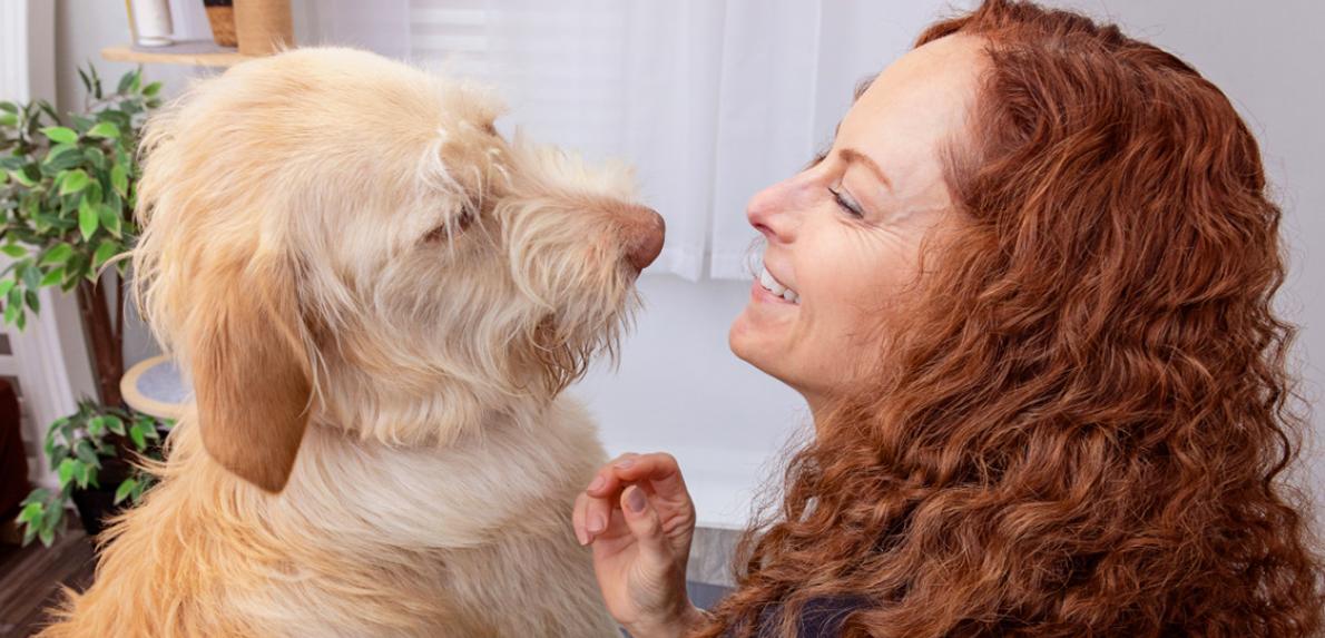 Profile of smiling person with a scruffy dog