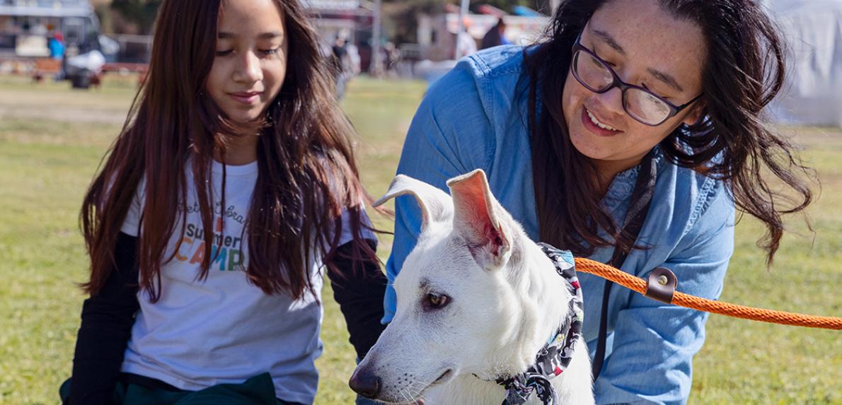 Two people adopting a dog at the Los Angeles Super Adoption