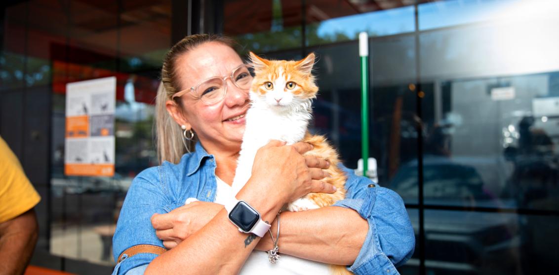 Smiling person holding a newly adopted cat in Salt Lake City