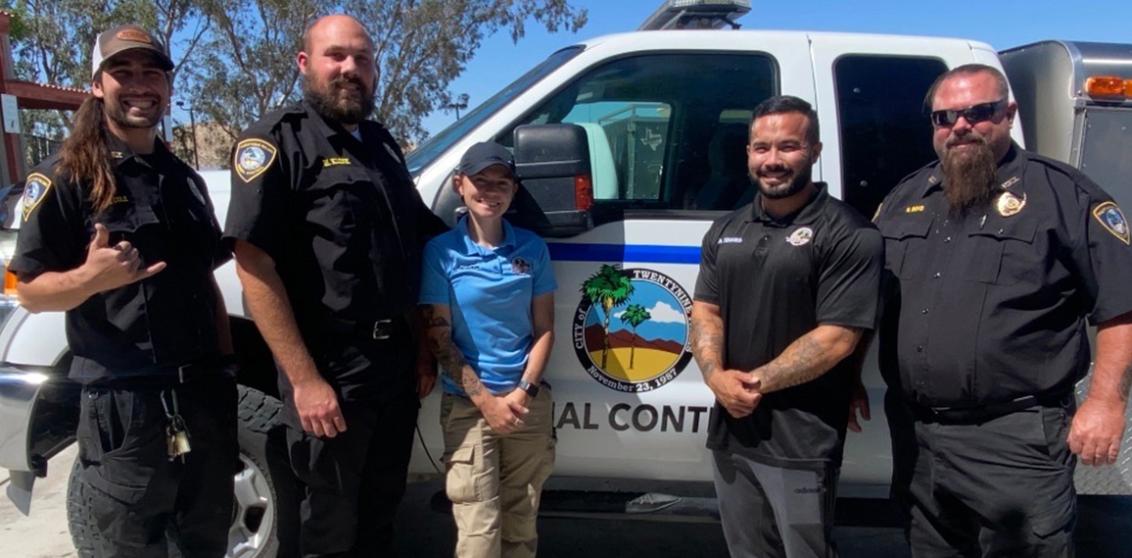 Palms N Paws animal control officers smiling in front of truck