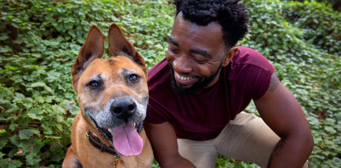 Person sitting outside with dog