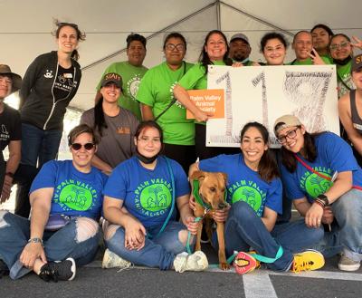 Group from Palm Valley Animal Society holding a sign with the number 117