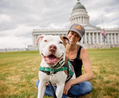 Woman with dog in front of capitol