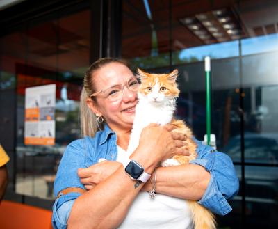 Smiling person holding a newly adopted cat in Salt Lake City