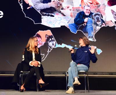 3 people talking on stage at conference