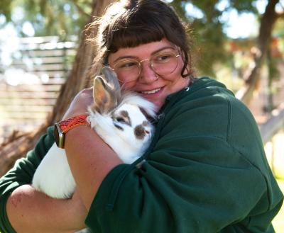 Smiling person holding a bunny