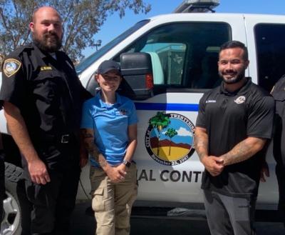 Palms N Paws animal control officers smiling in front of truck