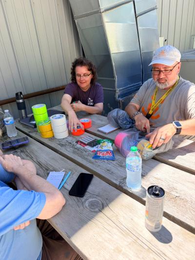 Deana and Tim at a table with various colors of duct tape
