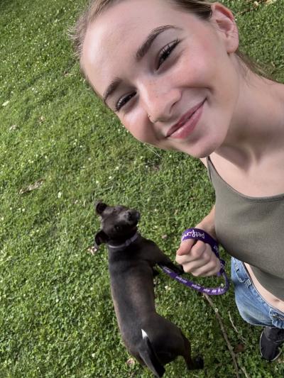 Selfie of an Animal Protective League staff person taking a dog out for a walk