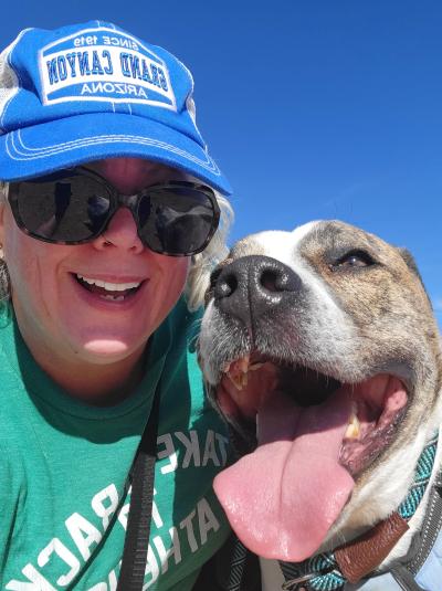 Selfie of Tupi the dog and his adopter, both smiling