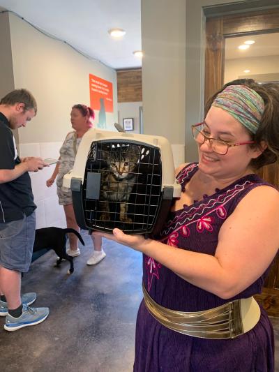 Tia holding Tinker the cat in a carrier