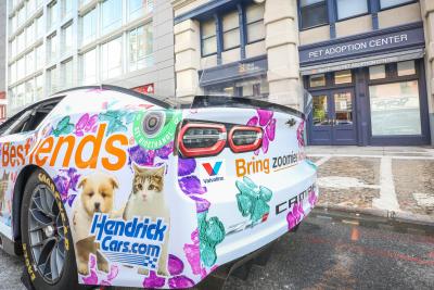 Back of the NASCAR Hendrick Motorsports No. 48 Ally Chevrolet Camaro ZL1 race car in front of the Best Friends Lifesaving Center in New York City