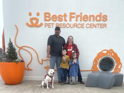 Annie the dog with her new family at the Best Friends Pet Resource Center