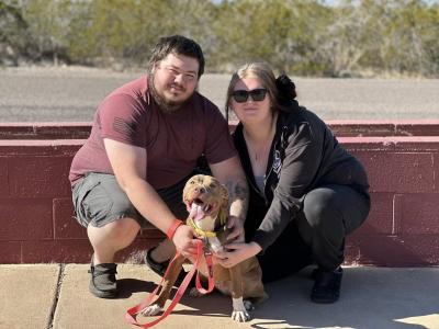 Rex the dog with his adopters