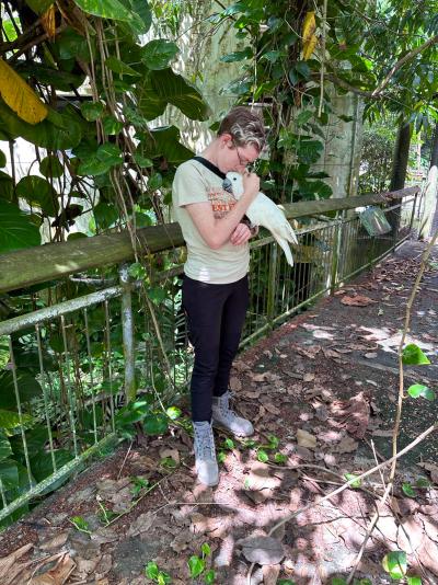 Person cuddling a cockatoo in the aviary in Puerto Rico