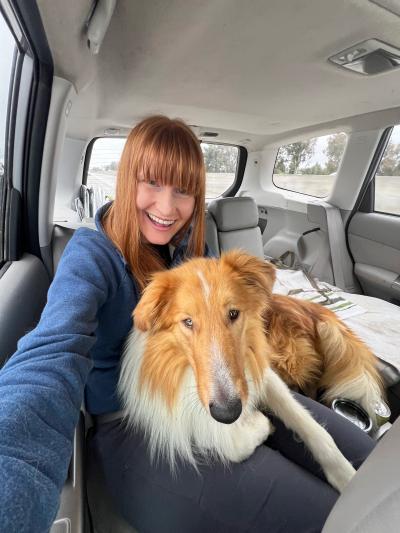 Selfie of Kileen with Friday the dog in a vehicle