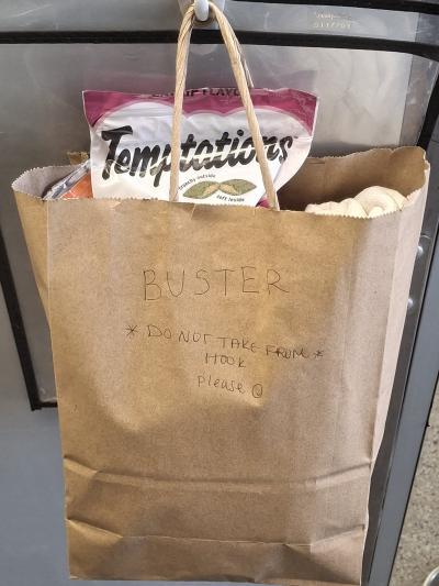 Paper bag from Mike containing treats and food for Buster and other cats