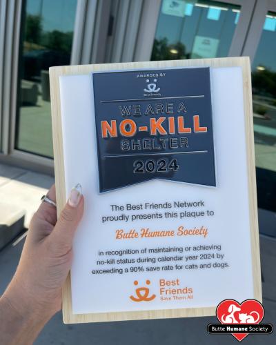 Hand holding the Butte Humane Society plaque