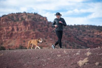 Person jogging with a dog on a leash