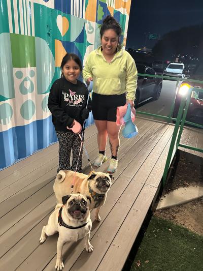 Family with two of their dogs outside on leashes