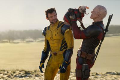 Deadpool holding Dogpool up, standing next to Wolverine