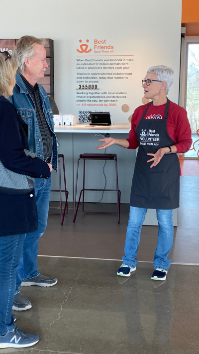 Volunteer Toni Dorsey talking to some people at the Best Friends Pet Resource Center in Bentonville