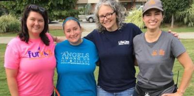 Four ladies standing together with landscape behind