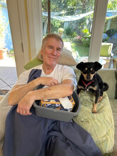 Eleanor the dog beside Mark when he was recovering from his injury