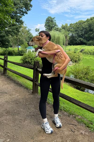 Lauren outside holding Eloise on a hike