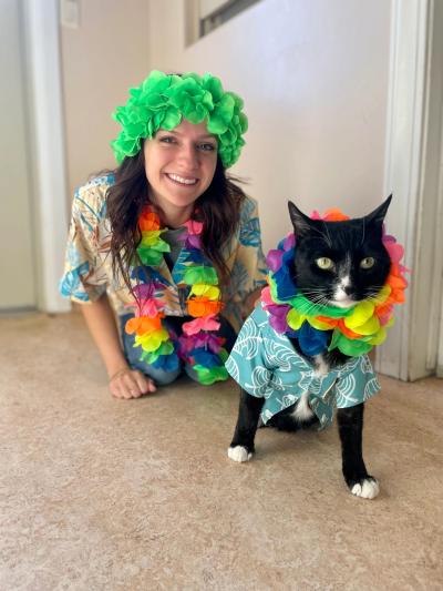 Emily and Hale the cat both wearing Hawaiian shirts and leis