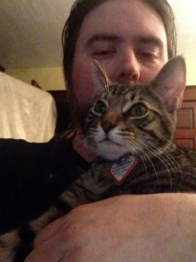 Erick Allen holding his cat Eddie