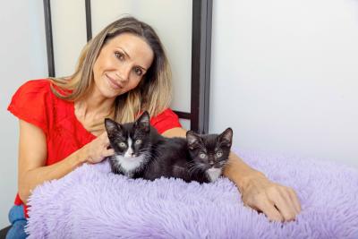 Frankie Giblin with two black and white foster kitten
