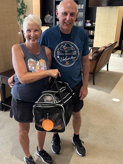 Judy and David Reynolds holding Frankie the cat in a carrier