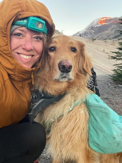 Emily Keddie outside in winter clothing with a dog