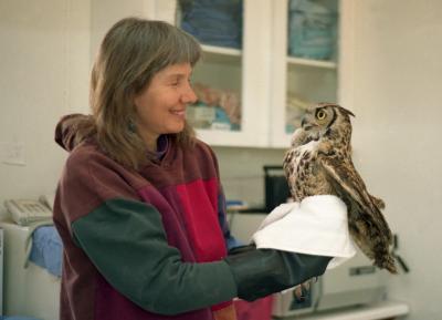 Vintage photo of Sharon St. Joan inside holding an owl in a towel