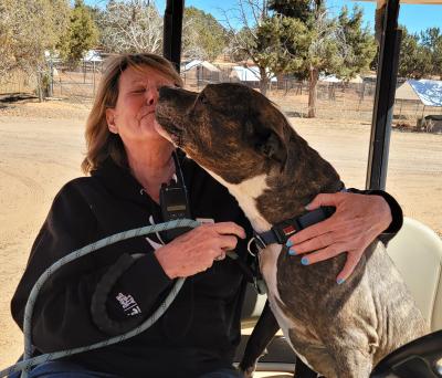 Joyce getting kissed by Legion the dog