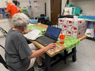 Volunteer Maggie Schroeder working on a computer