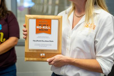Person holding the City of Humble, Texas Animal Shelter 2025 no-kill plaque from Best Friends